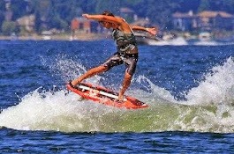 A Wake Surfer Executes a Mid-Air Trick on a Red Wakesurf Board